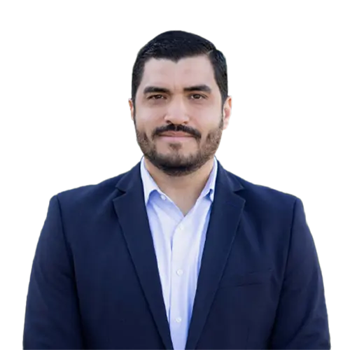 Javier Vargas professional headshot wearing a navy blazer and light dress shirt against a neutral background.